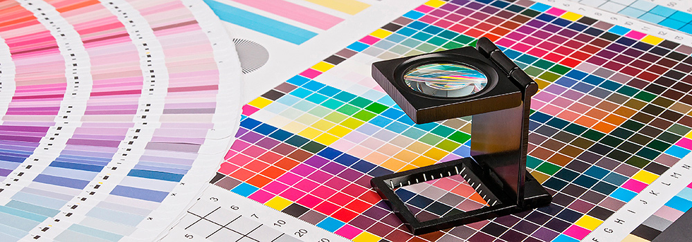 Magnifying glass on top of colour charts